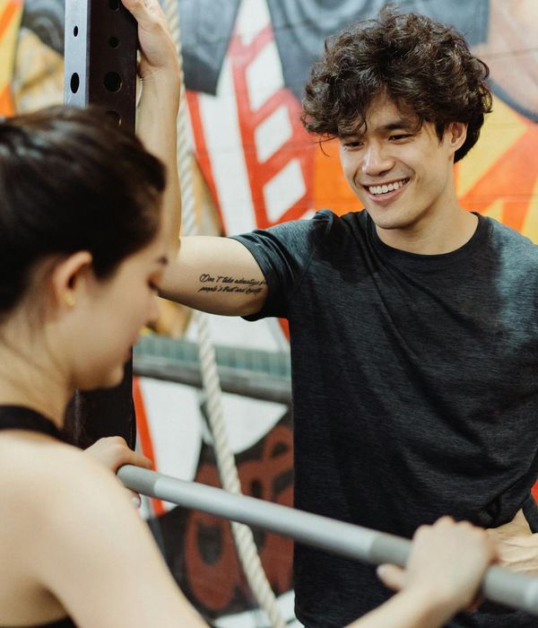 Man looking energized and refreshed after a workout session, smiling slightly.